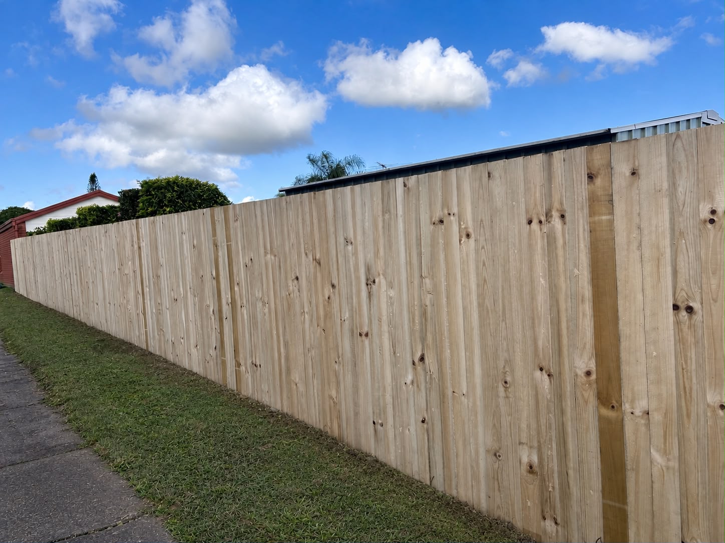 New treated pine paling fence along a suburban footpath, Brisbane Southside