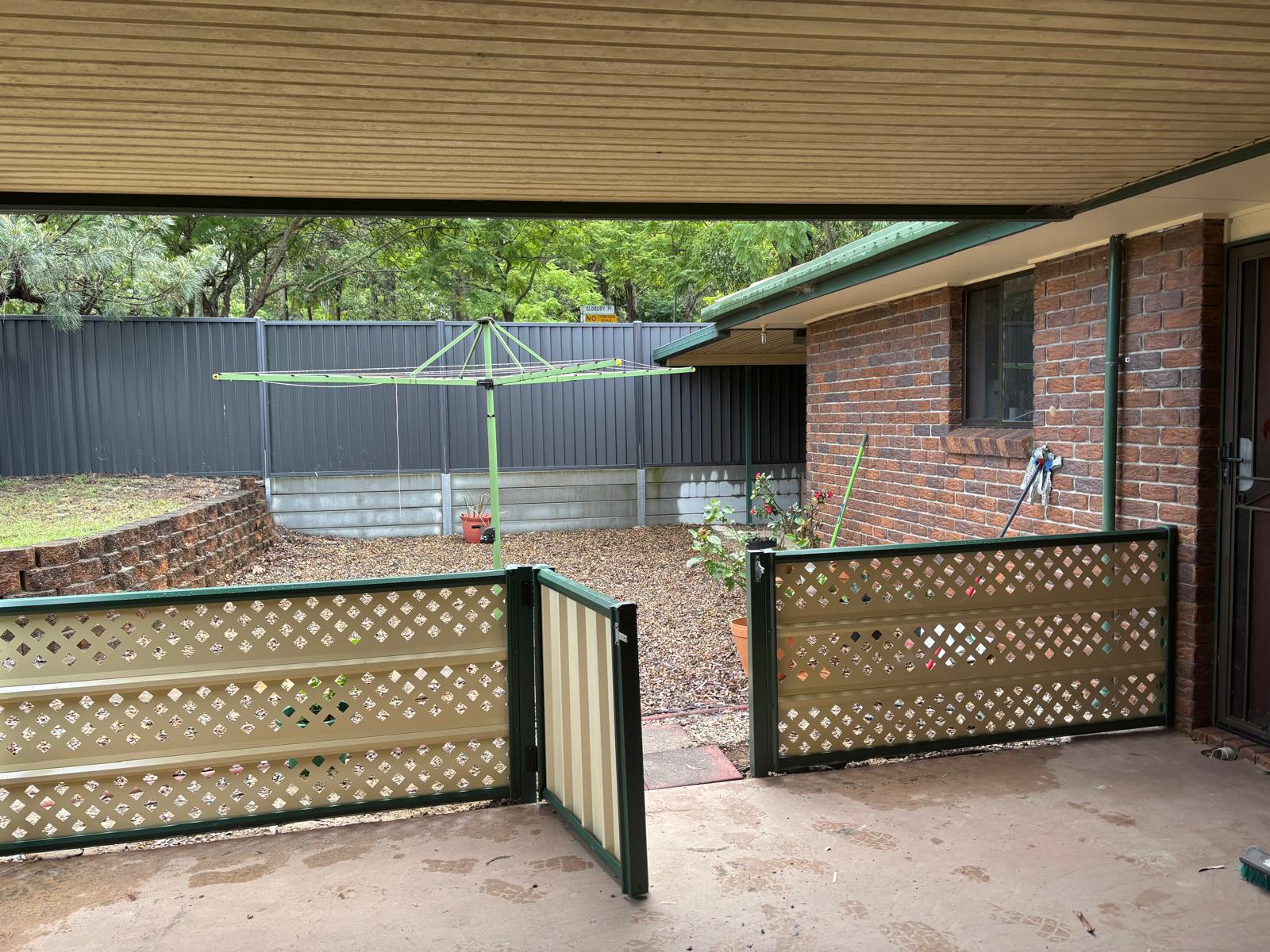 Lattice fence and gate in covered courtyard