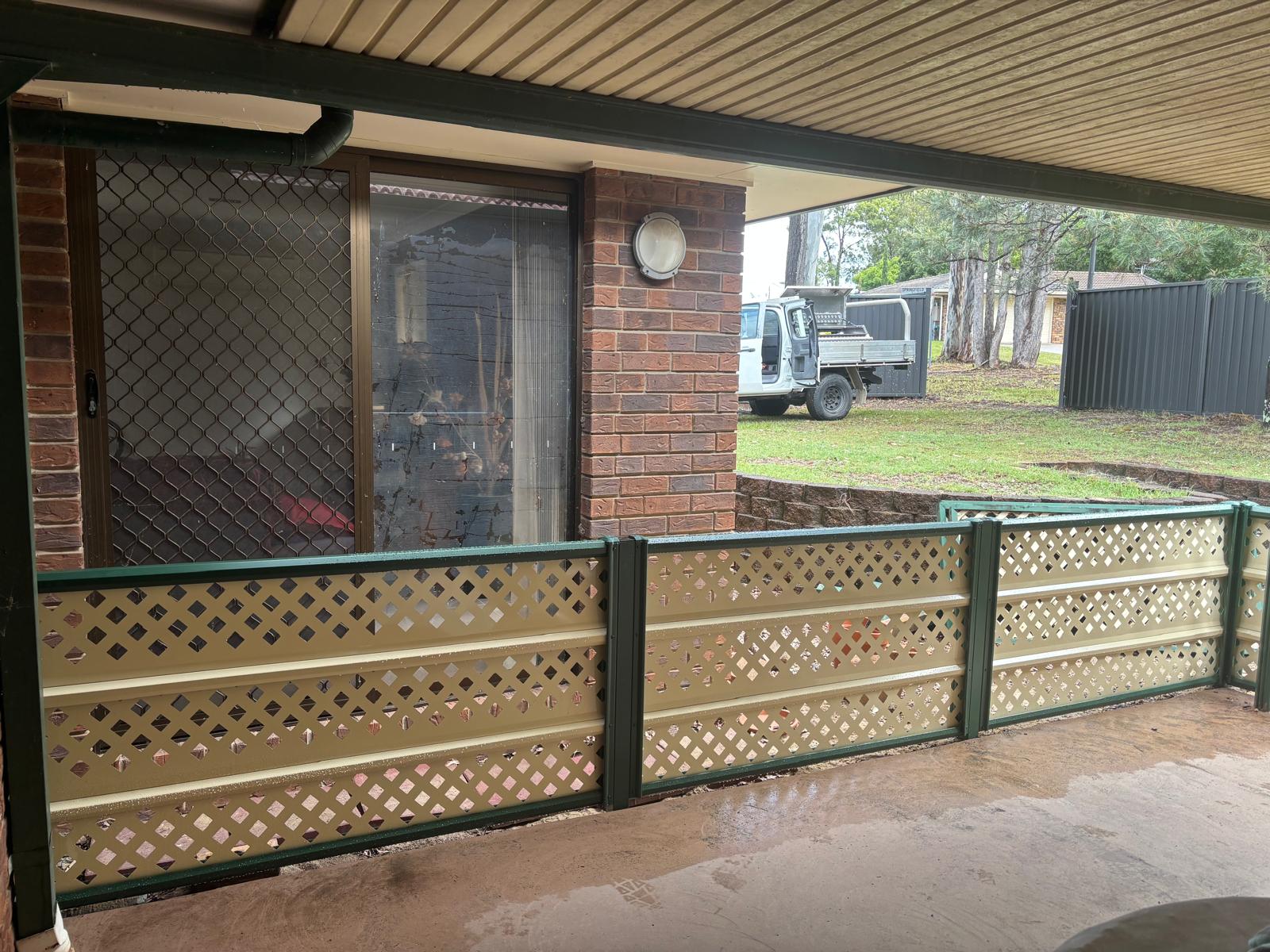Lattice front porch fence in cream and green