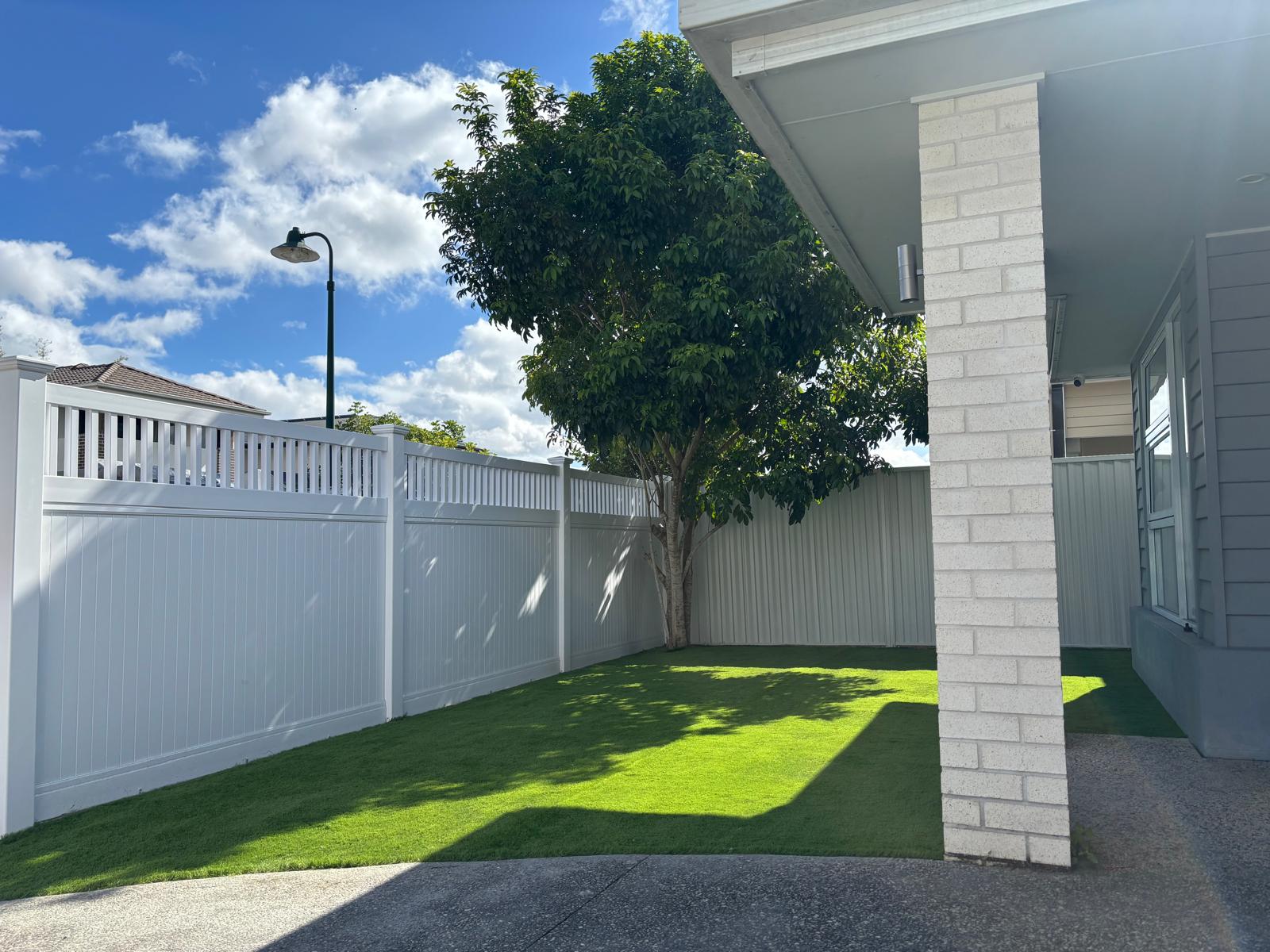 White PVC fence around a modern home