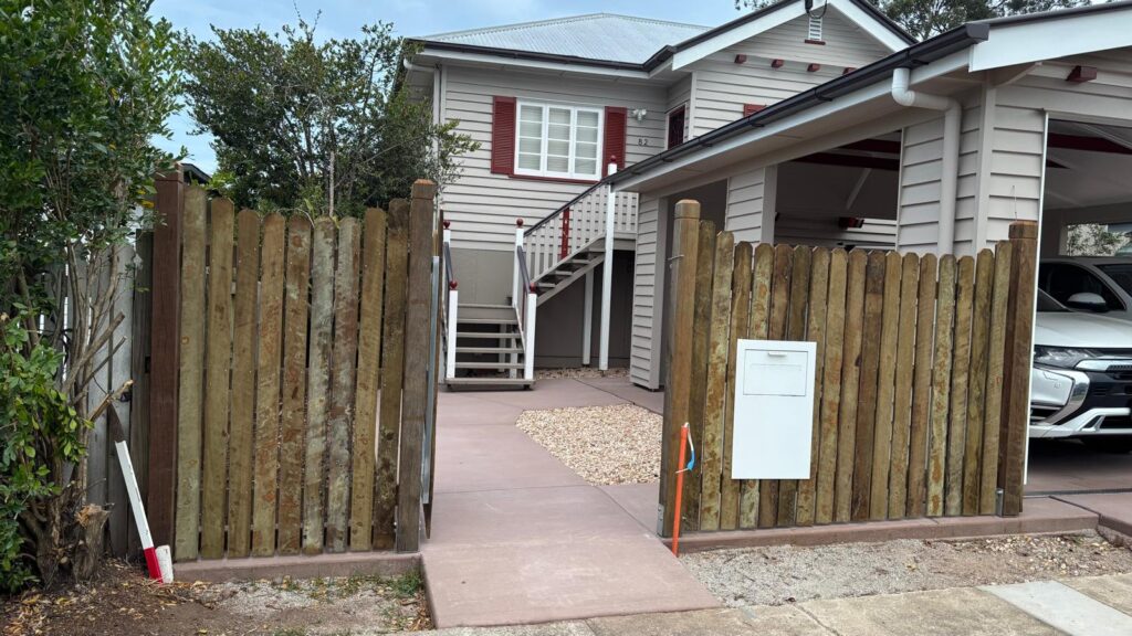 Open pedestrian gate in the custom hardwood frontage