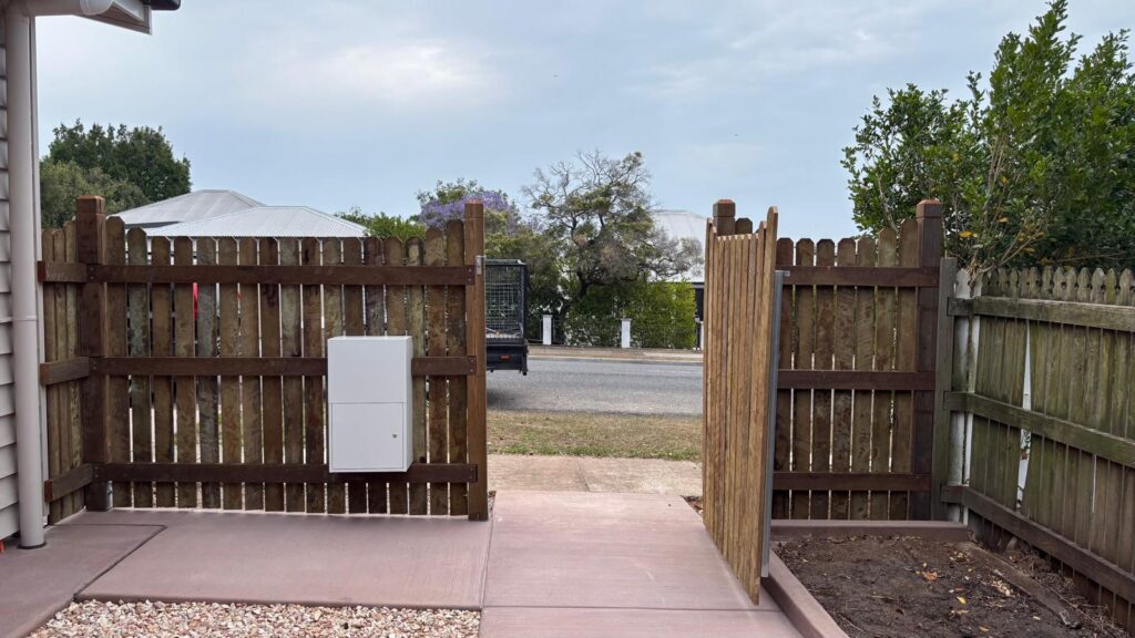 Open pedestrian gate viewed from inside the property