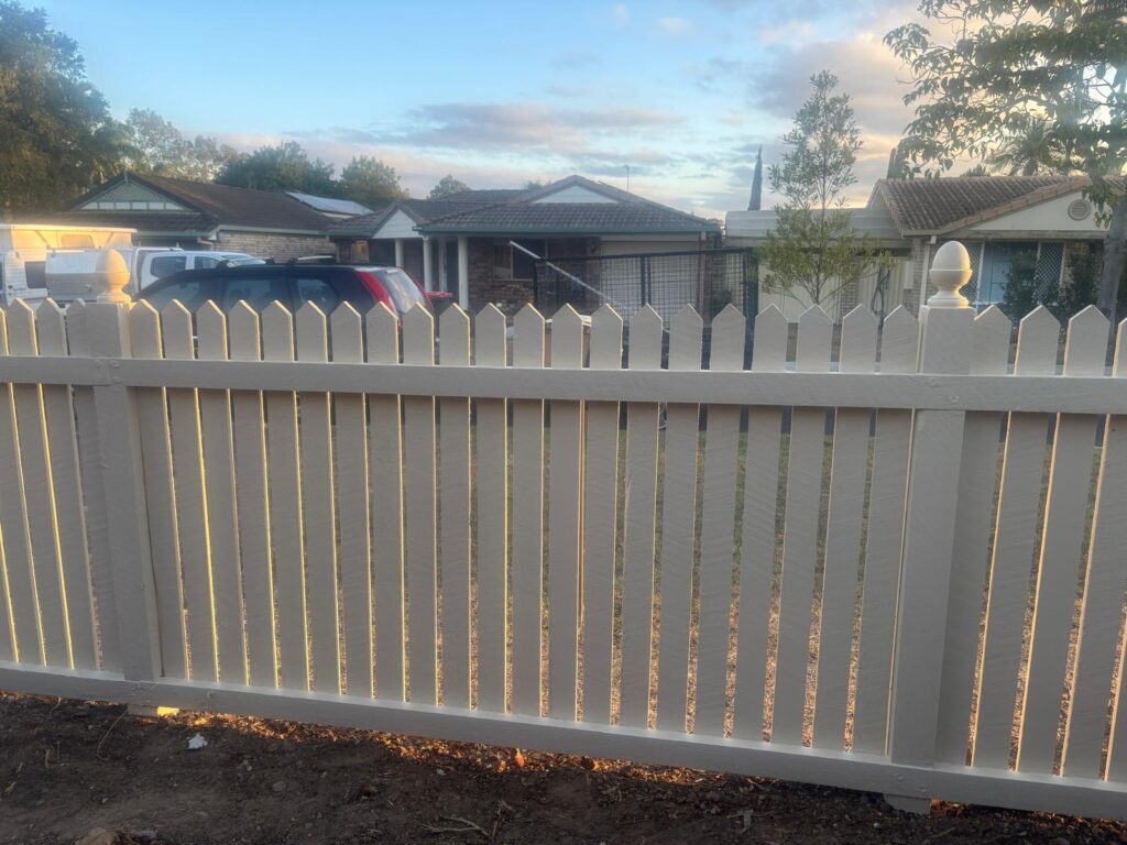 Inside face of the painted timber fence and horizontal rails in Forest Lake
