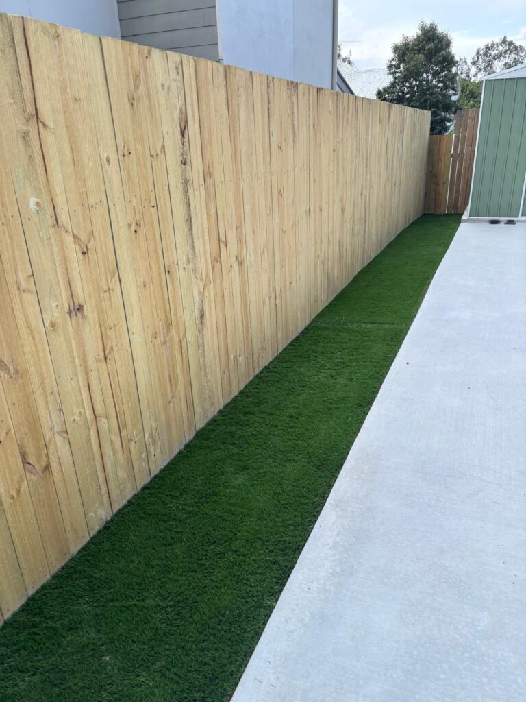 Long view of the timber side fence and synthetic grass finish in Richlands