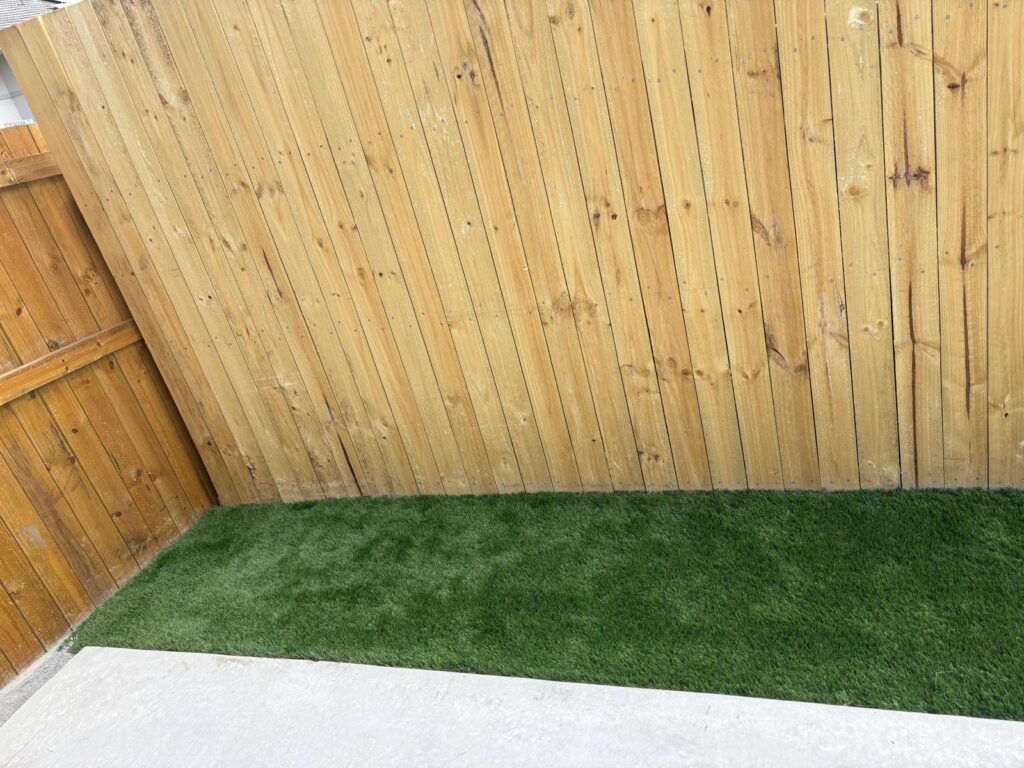 Synthetic grass finish in the corner of the small rear yard in Richlands
