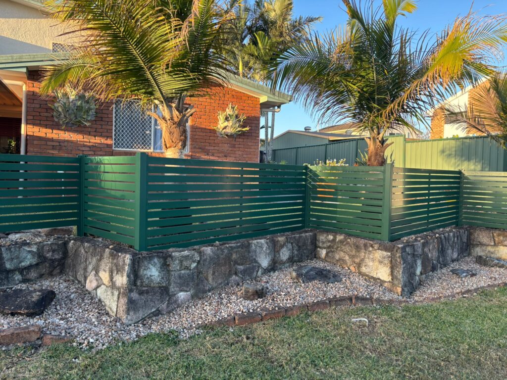 Cottage Green aluminium slat panels above the existing stone garden edge in Oxley
