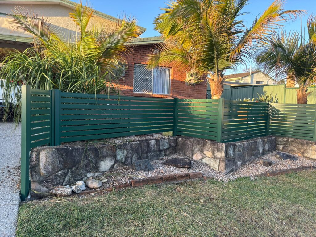 Garden frontage with Cottage Green slats and palm trees in Oxley