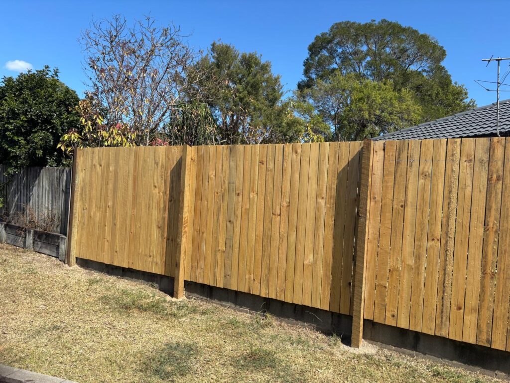 Street view of the timber boundary fence and hardwood posts in Jindalee