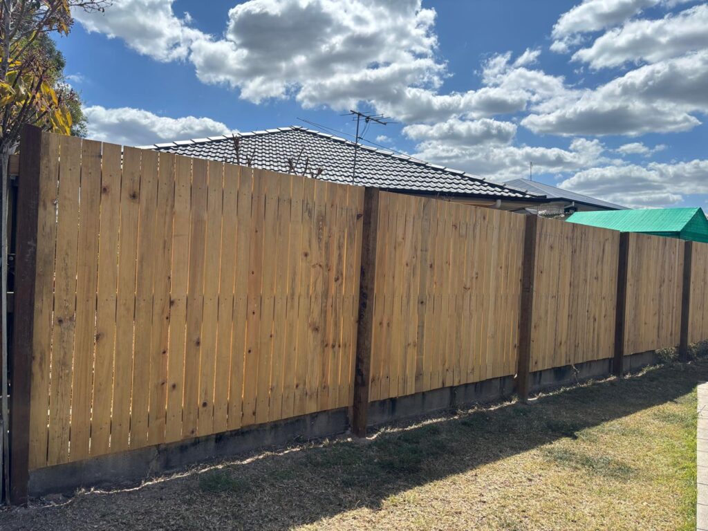 Timber fence and hardwood posts along the lawn boundary in Jindalee