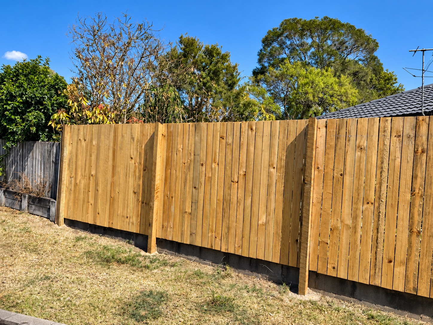 Hampton style timber boundary fence with solid hardwood posts in Jindalee