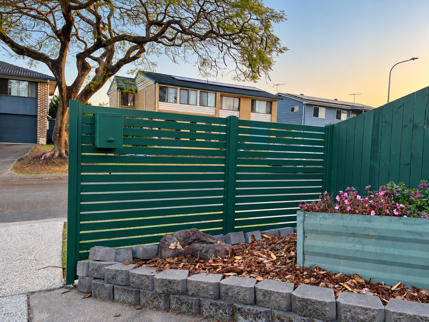 Cottage Green aluminium slat fence and mailbox beside the garden in Oxley