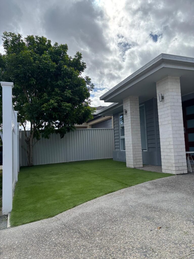 Front yard with synthetic grass and Colourbond fence